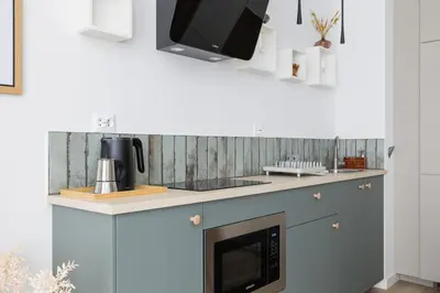 a kitchen with a counter with a microwave and a stove at Luxury Studio - Lwowska 10 street in Kraków