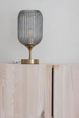 a lamp on top of a wooden table at Luxury Studio with an AC - Lwowska 10 street in Kraków