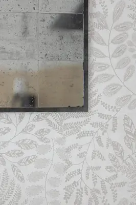 a mirror on a wall with a leaf pattern at Luxury Studio with an AC - Lwowska 10 street in Kraków