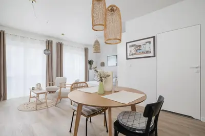 a dining room and living room with a table and chairs at Luxury Studio with an AC - Lwowska 10 street in Kraków