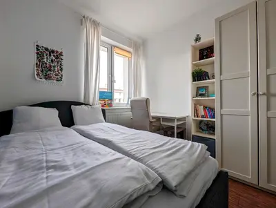 a bedroom with a bed and a desk and a window at Urzędnicza 23 by Homeprime in Kraków