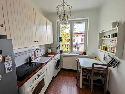 a kitchen with a sink and a table and a window at Urzędnicza 23 by Homeprime in Kraków