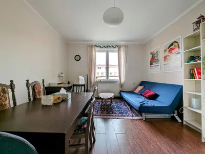 a living room with a blue couch and a table at Urzędnicza 23 by Homeprime in Kraków