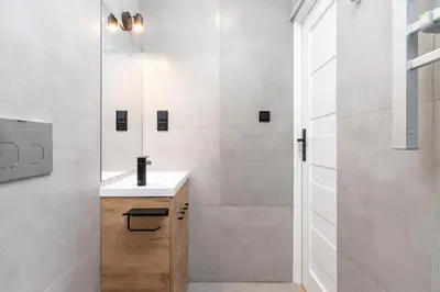 a bathroom with a sink and a shower at Studio Apartment - Radziwiłłowska 27 in Kraków