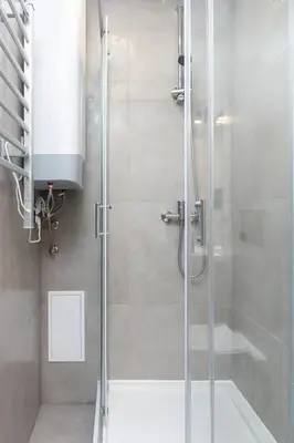 a shower with a glass door in a bathroom at Studio Apartment - Radziwiłłowska 27 in Kraków