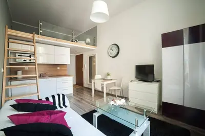 a living room with a bed and a glass table at Apartment in the centre - Old Town in Kraków