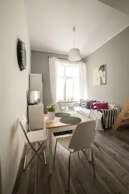 a living room with a table and chairs and a couch at Apartment in the centre - Old Town in Kraków