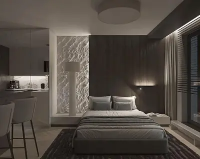 a bedroom with a large bed and a kitchen at Prestiżowy apartament B in Kraków
