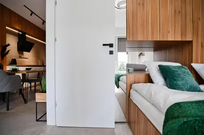 a bedroom with a bed and a dining room at Apartament Venus by Housine in Zator