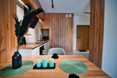a kitchen with a wooden table with a vase on it at Apartament Venus by Housine in Zator