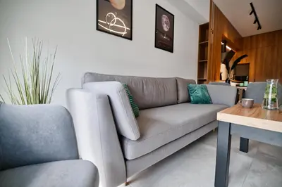 a living room with a couch and a table at Apartament Venus by Housine in Zator