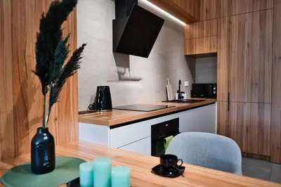 a kitchen with a table and a vase with a plant at Apartament Venus by Housine in Zator