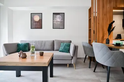 a living room with a couch and a table at Apartament Venus by Housine in Zator