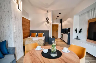 a room with a dining table and a bedroom at Apartament Mars by Housine in Zator