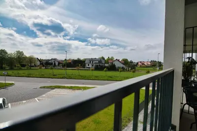 a balcony with a view of a street and houses at Apartament Mars by Housine in Zator