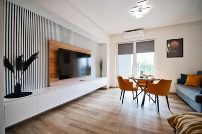 a living room with a television and a table and chairs at Apartament Mars by Housine in Zator