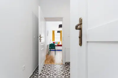 a hallway with a door and a room with a table at Apartment for two Krakowska 16 Street in Kraków