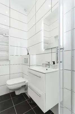 a white bathroom with a toilet and a sink at Apartment for two Krakowska 16 Street in Kraków