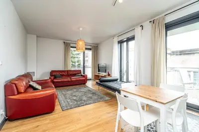 a living room with a red couch and a table at RentPlanet - Kamienica Retmana in Kraków