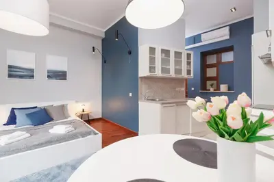 a bedroom with a bed and a vase of flowers at Main Square Apartment - Old Town in Kraków