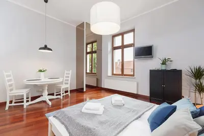 a living room with a couch and a table at Main Square Apartment - Old Town in Kraków