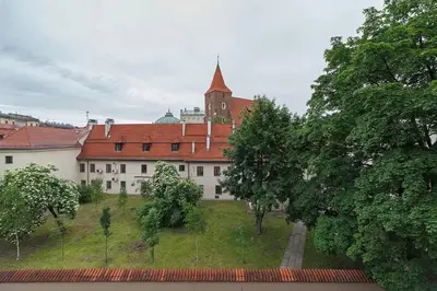 a large white building with a red roof at Main Square Apartment - Old Town in Kraków