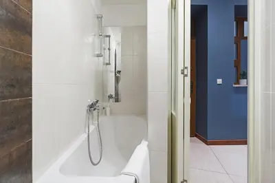 a bathroom with a bath tub with a shower at Main Square Apartment - Old Town in Kraków