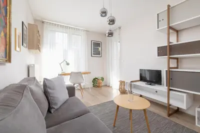 a living room with a couch and a tv at Apartment with Balcony - Masarska 8 Street in Kraków