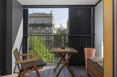 a balcony with a table and a view of a building at Apartment with Balcony - Masarska 8 Street in Kraków