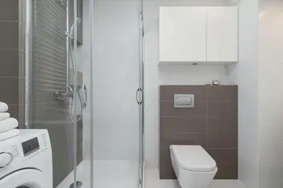 a bathroom with a toilet and a glass shower at Apartment with Balcony - Masarska 8 Street in Kraków