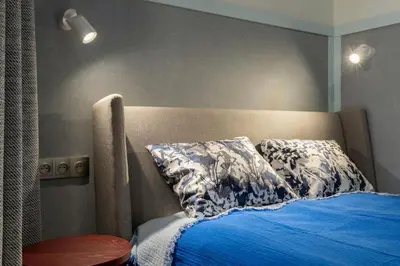 a bedroom with a bed with blue and white pillows at Dietla 11 - Art Studio for 2 in Kraków