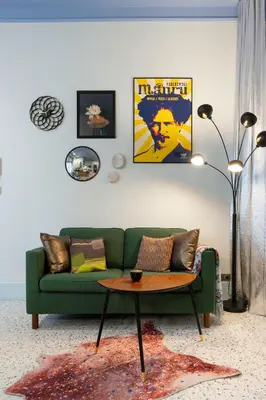 a living room with a green couch and a table at Dietla 11 - Art Studio for 2 in Kraków