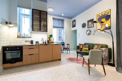 a kitchen and living room with a couch and a table at Dietla 11 - Art Studio for 2 in Kraków