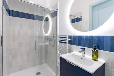 a bathroom with a sink and a shower and a mirror at Dietla 11 - Art Studio for 2 in Kraków