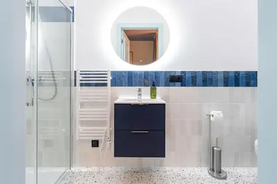 a bathroom with a sink and a mirror at Dietla 11 - Art Studio for 2 in Kraków