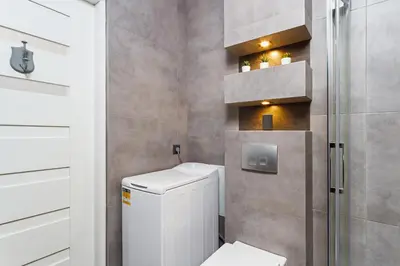 a small bathroom with a toilet and a shower at Charming Studio - 54 Starowislna street in Kraków