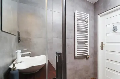 a bathroom with a sink and a shower at Charming Studio - 54 Starowislna street in Kraków