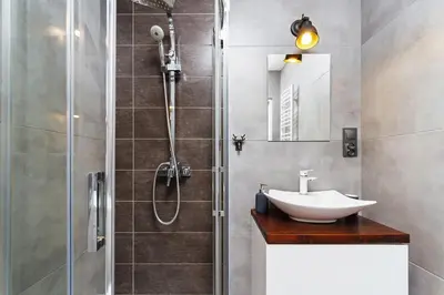 a bathroom with a sink and a shower at Charming Studio - 54 Starowislna street in Kraków
