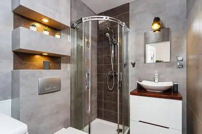 a bathroom with a shower and a sink at Charming Studio - 54 Starowislna street in Kraków