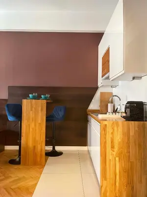 a kitchen with a counter and two stools at Well-connected Apartment in Old Town Cracow in Kraków