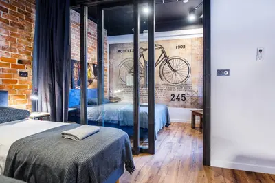 a bedroom with a brick wall with a bike on the wall at STAR66 Apartment, Air-cond in Kraków