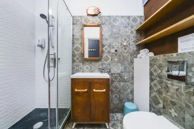 a bathroom with a shower and a sink and a mirror at STAR66 Apartment, Air-cond in Kraków