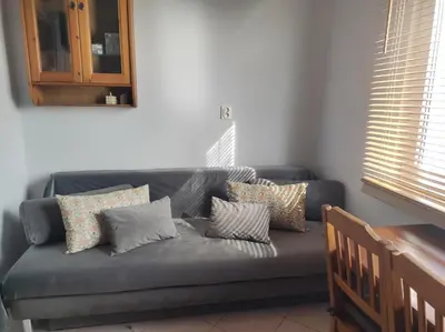 a couch with pillows on it in a living room at Dwupokojowy Apartament 700 m od Szpital Prokocim in Kraków