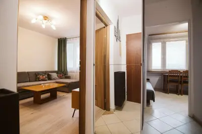 a living room with a couch and a table at Dwupokojowy Apartament 700 m od Szpital Prokocim in Kraków
