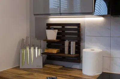 a kitchen with a counter with knives and a roll of paper towels at Dwupokojowy Apartament 700 m od Szpital Prokocim in Kraków