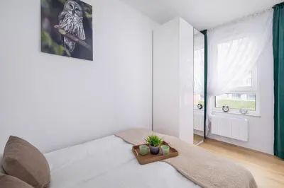 a bedroom with a white bed and a window at Stylish Apartment near Tauron Arena by Rent like home in Kraków
