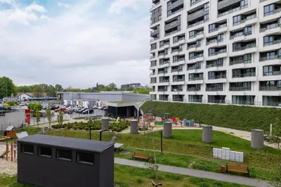 a building in front of a large building at Stylish Apartment near Tauron Arena by Rent like home in Kraków