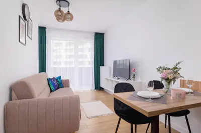 a living room with a couch and a table at Stylish Apartment near Tauron Arena by Rent like home in Kraków