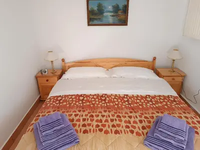 a bedroom with a bed with two blue towels on it at Apartament u Moni in Sucha Beskidzka