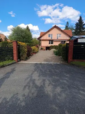 a house with a driveway in front of a house at Apartament u Moni in Sucha Beskidzka